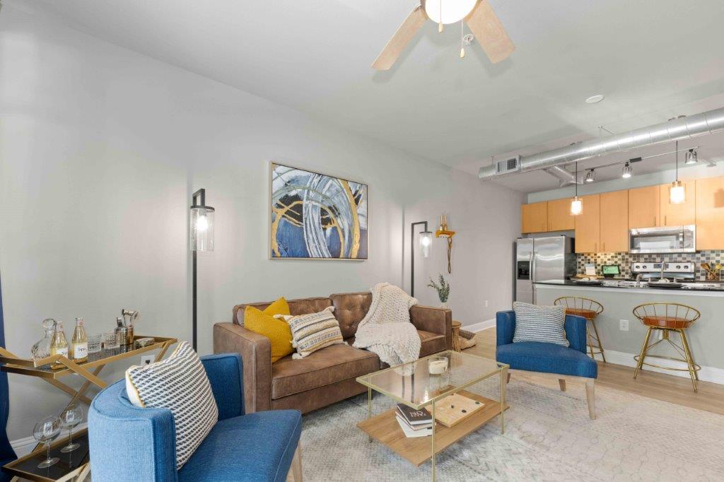 A Living Room With Blue Couch at Mosaic South End Apartments, North Carolina, 28203